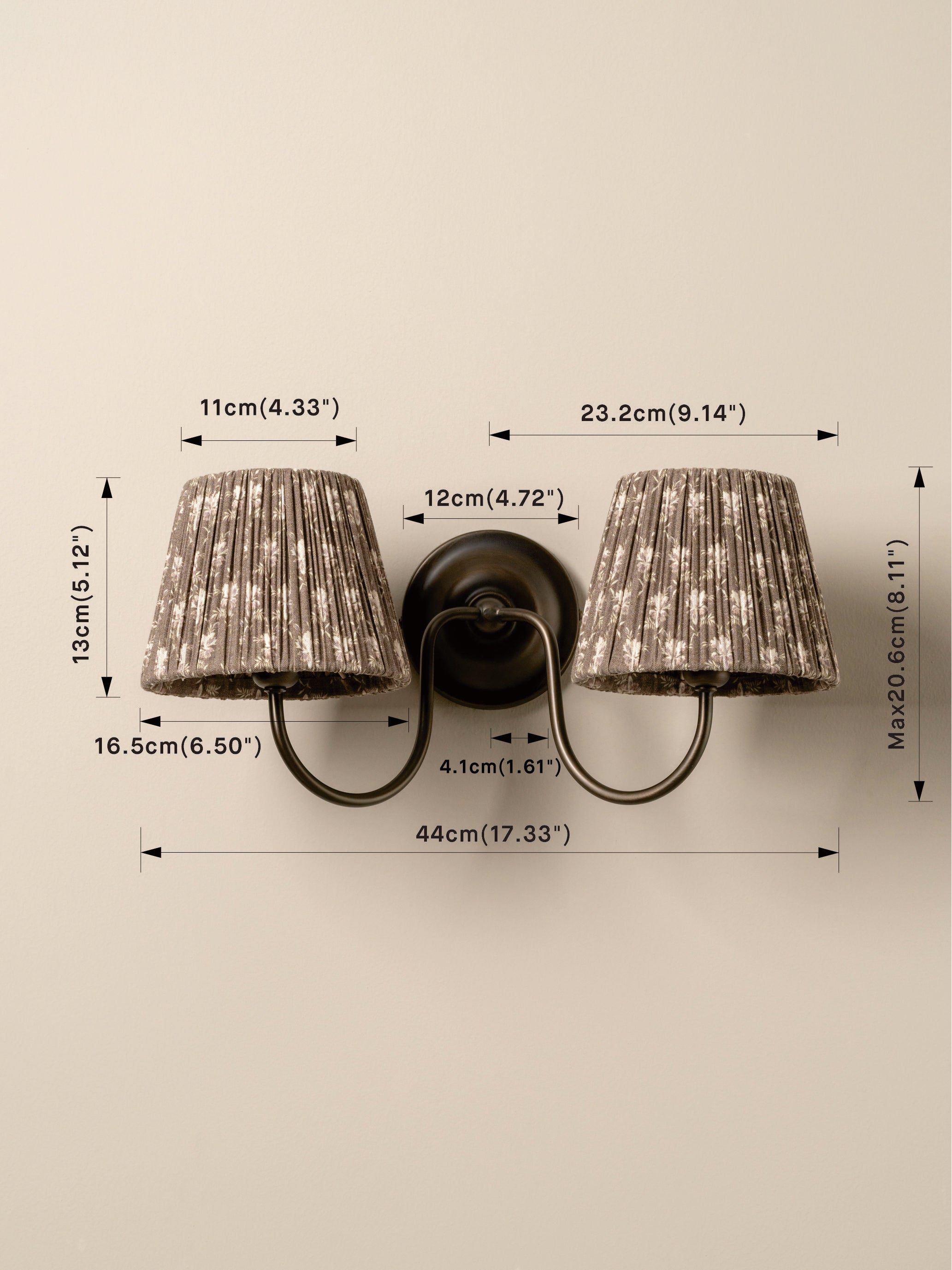 A two-light wall sconce with textured gray pleated shades and a dark metal mount, shown with overlaid dimension arrows and measurements on a plain light background.