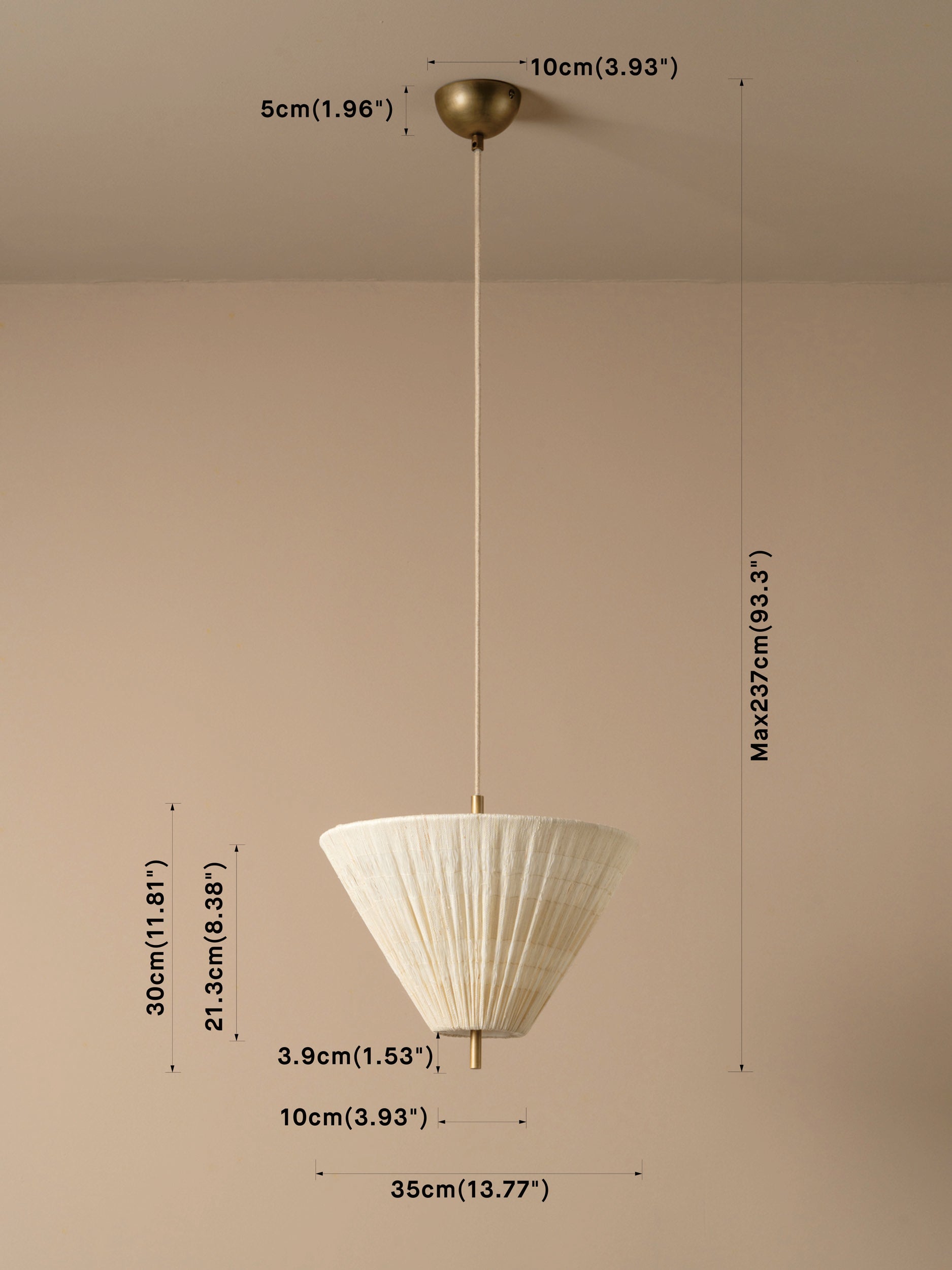 A hanging pendant light with a white pleated conical shade and a brass-toned ceiling mount and cord, shown against a plain beige wall with overlaid dimension labels and measurement lines.