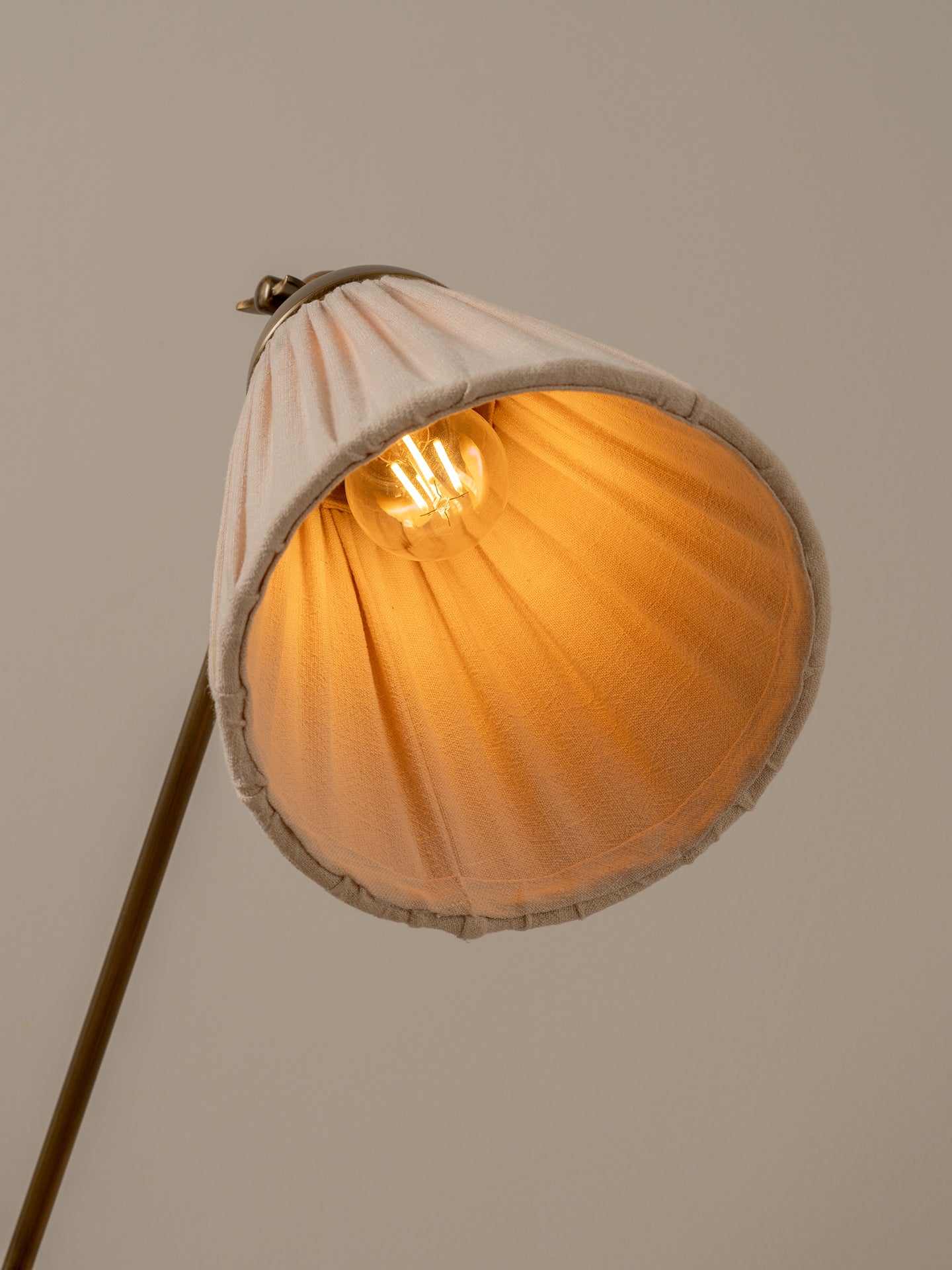 Lamp with a shell-shaped shade on a plain background