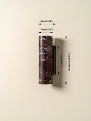 Marble-patterned cylindrical object with dimensions indicated on a beige background