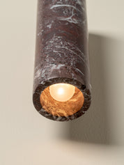 Marble-textured cylindrical light fixture on a neutral background