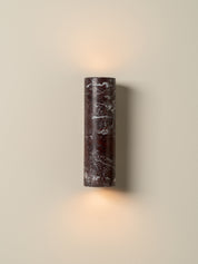 Cylindrical wall light fixture on a beige wall