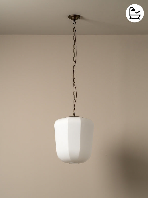 White pendant light hanging from a chain against a beige wall.