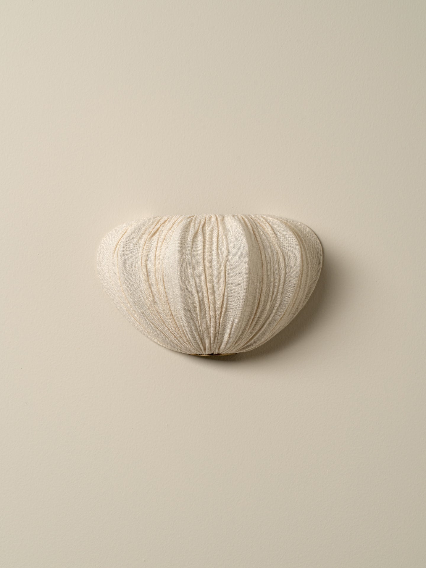 cream color, mounted on a solid beige wall.