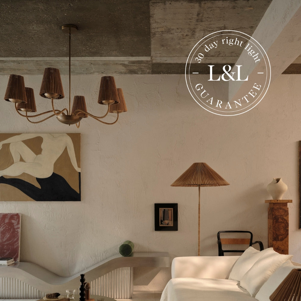 Living room with chandelier, lamp, and artwork, featuring L&L logo.