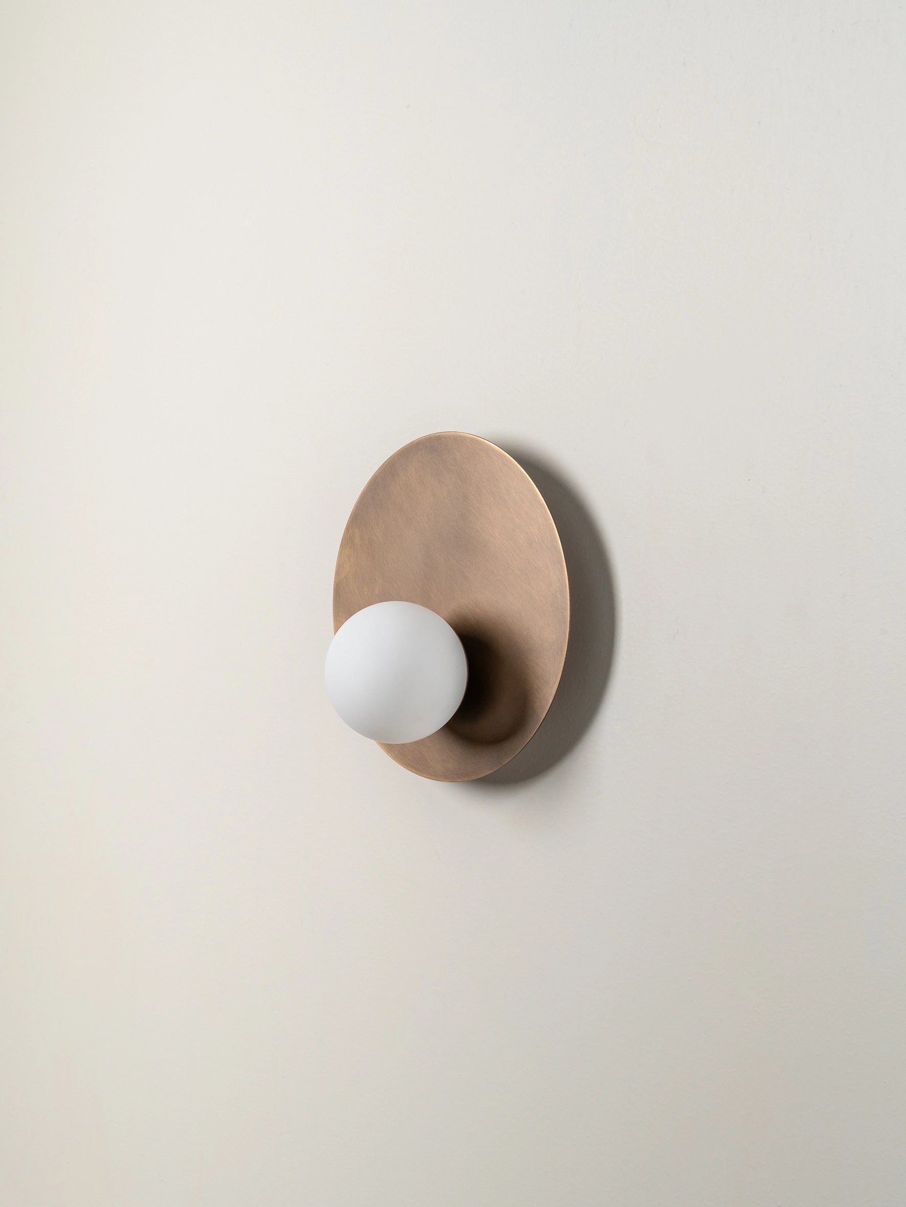 Luna - aged brass and opal disc wall light | Wall light | lights & lamps | Modern affordable designer lighting