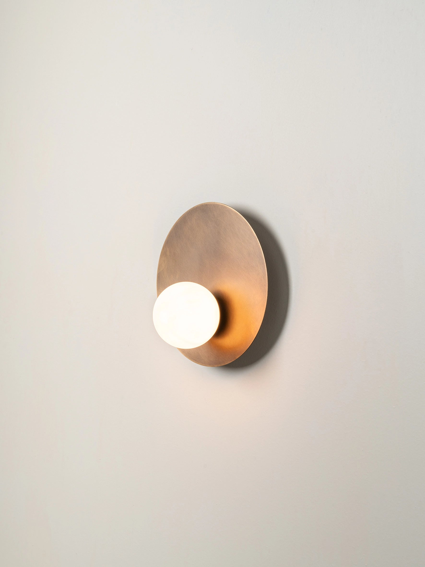 Luna - aged brass and opal disc wall light | Wall light | lights & lamps | Modern affordable designer lighting