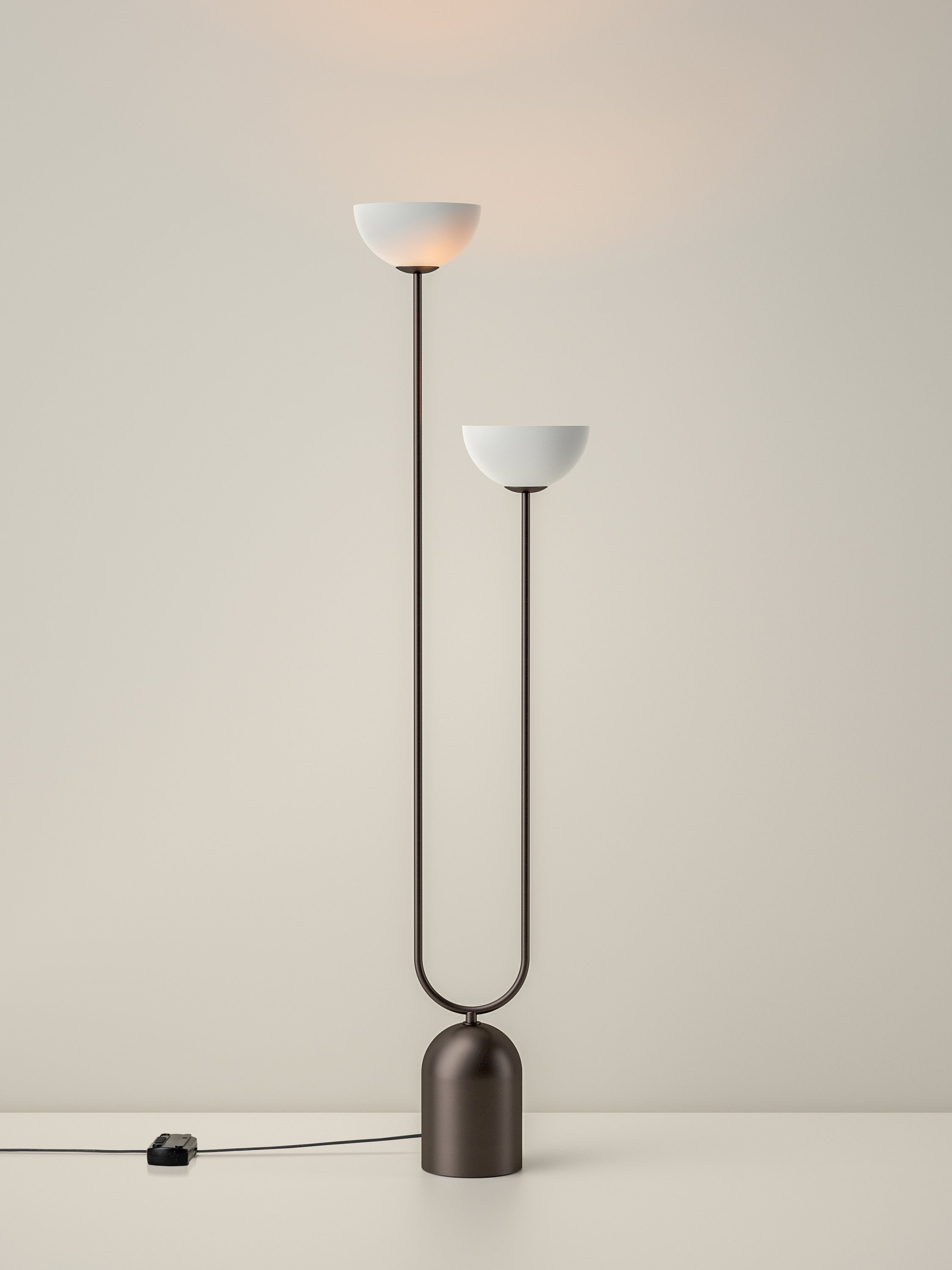 Modern floor lamp with two white lampshades on a beige background